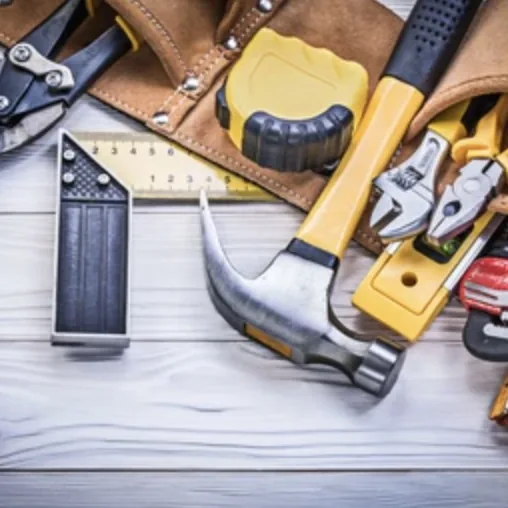 Handyman tool belt with hammer, wrench, and pliers used for restoration and repair work in San Antonio